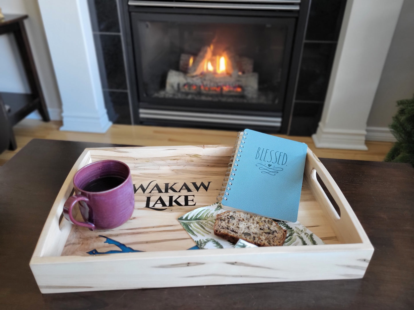 Staged view of custom epoxy lake serving tray made in Saskatoon, Saskatchewan with journal and coffee mug