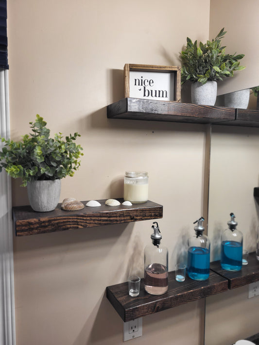 Three handcrafted floating wooden shelves mounted in a bathroom made in Saskatoon, Saskatchewan