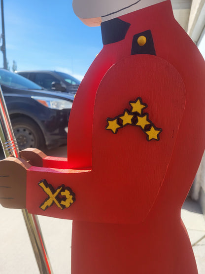 Carved poplar insignia details on the sleeve of a wooden RCMP display