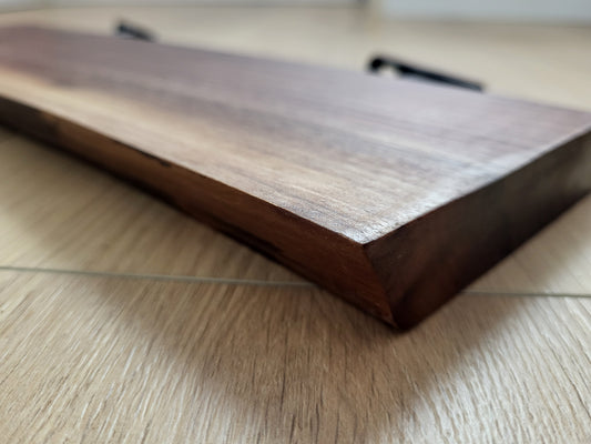 Close-up of the finished edge and grain on a live-edge wood shelf